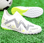 Pair of Galactic Men’s Turf Football Boots white patterned next to a football on green artificial grass field background