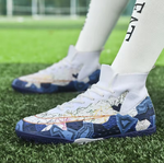 Tempesta Men’s Turf Football Boots in white with blue graphic details worn on artificial grass field with a football in the background