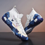 Tempesta Men’s Firm Ground Football Boots in white with blue sole and colourful crack design displayed on a reflective surface