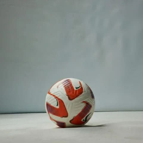 Vector football displayed in a studio setting on a white surface with a grey background.